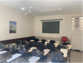 Sala de aula com carteiras e lousa